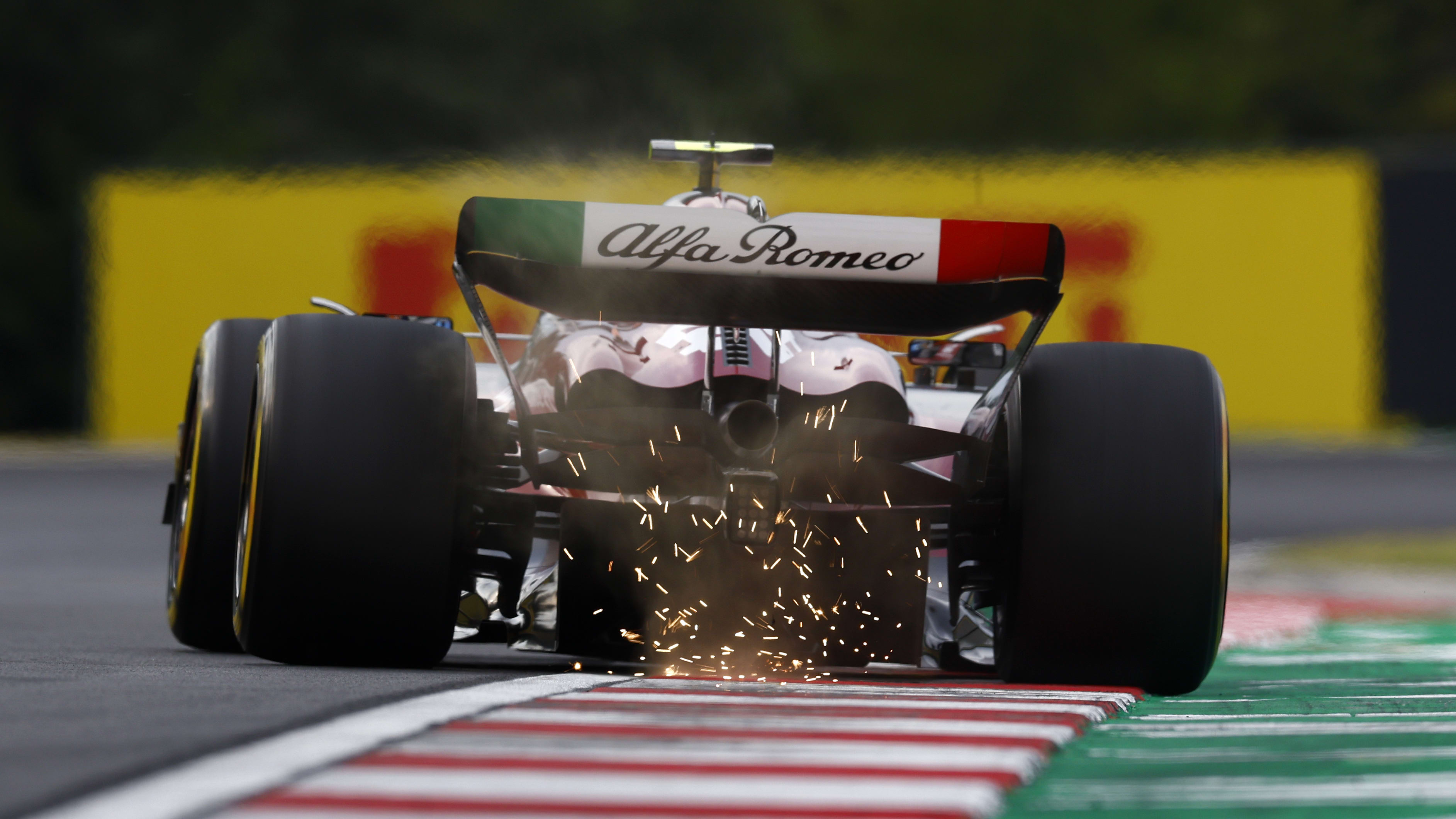 BUDAPEST, HUNGARY - JULY 22: Sparks fly behind Zhou Guanyu of China driving the (24) Alfa Romeo F1