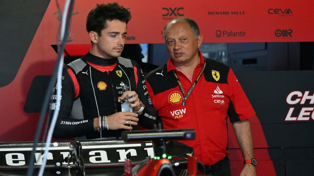 Ferrari's Monegasque driver Charles Leclerc (L) speaks with Ferrari's team principal Frederic