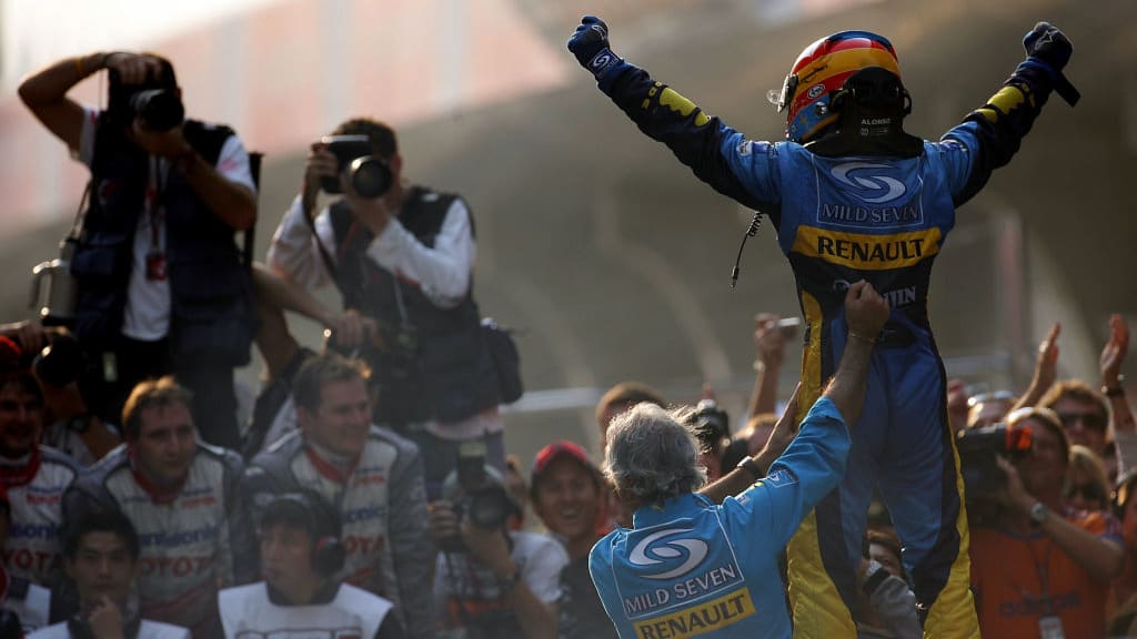 SHANGHAI, CHINA - OCTOBER 16:  Fernando Alonso of Spain and Renault celebrates with the team